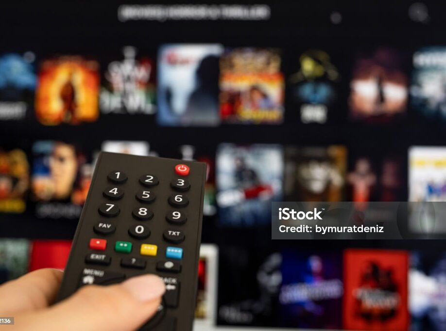 Woman hand holding tv remote.